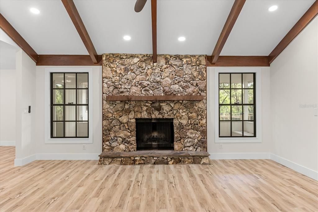 Empty room, Fireplace, Interior, Recessed Lighting, Stone Walls, Wooden Beams, Wood Texture Flooring