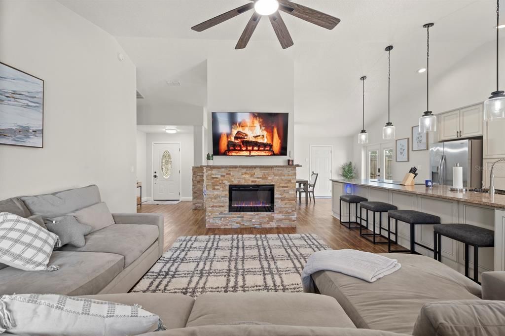 Dining room, Fireplace, Interior, Kitchen, Living room, Pendant Lights, Recessed Lighting, Stainless Steel Appliances, Wood Texture Flooring