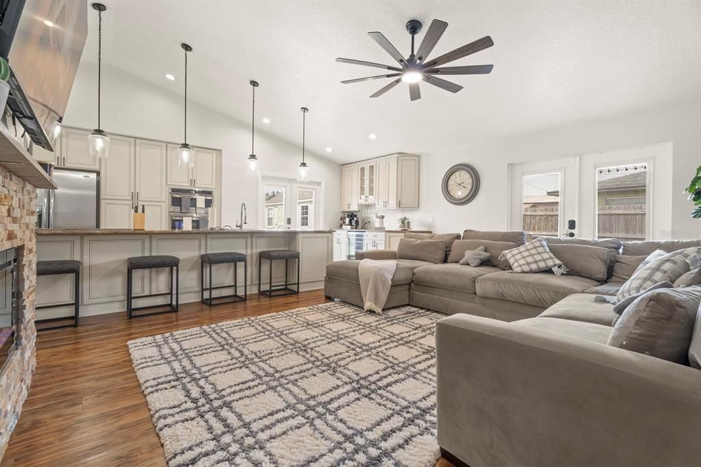 Fireplace, Interior, Kitchen, Living room, Pendant Lights, Recessed Lighting, Stainless Steel Appliances, Wood Texture Flooring