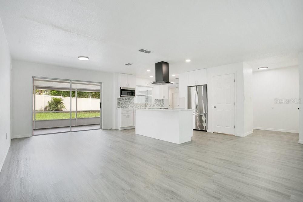 Empty room, Interior, Kitchen, Recessed Lighting, Stainless Steel Appliances, Wood Texture Flooring