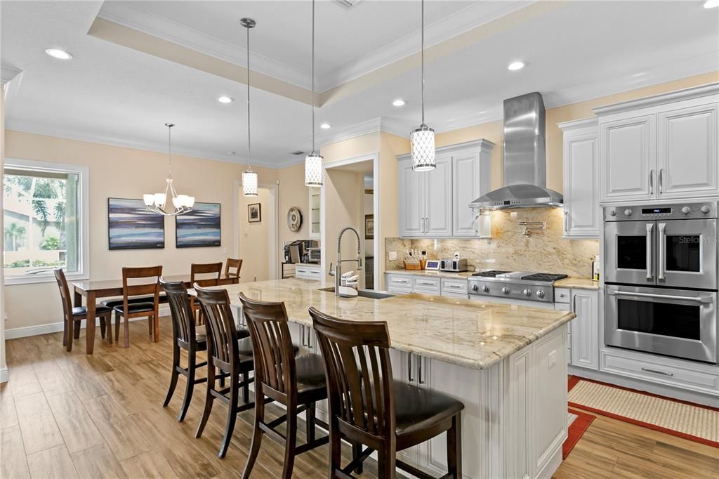 Chandelier, Dining room, Interior, Kitchen, Pendant Lights, Recessed Lighting, Stainless Steel Appliances, Wood Texture Flooring