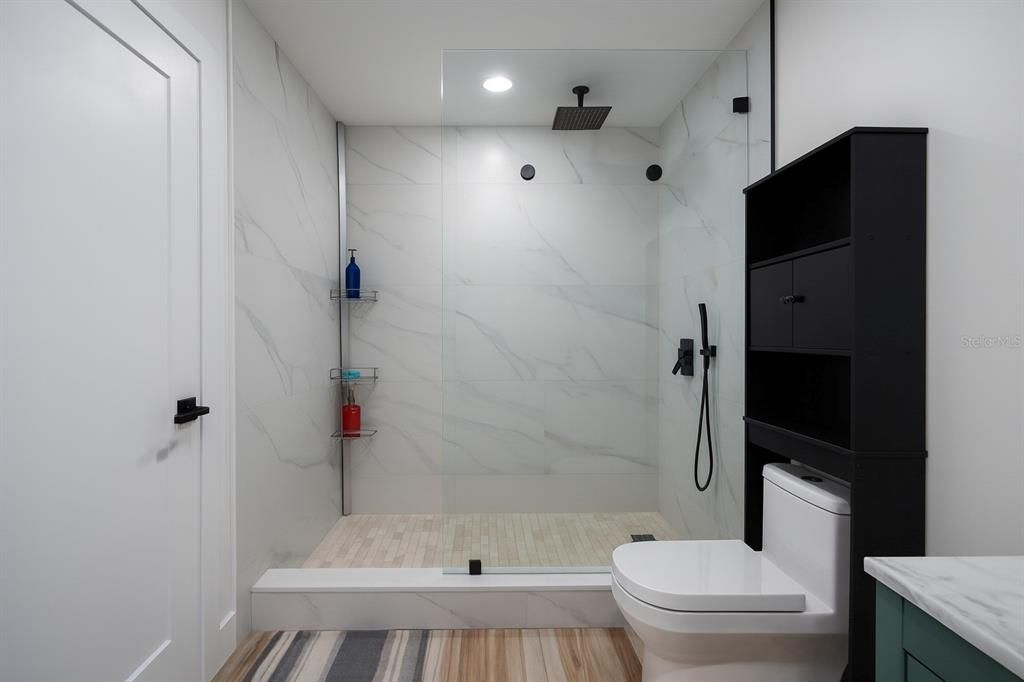 Bathroom, Glass Shower, Interior, Marble Walls, Recessed Lighting, Wood Texture Flooring