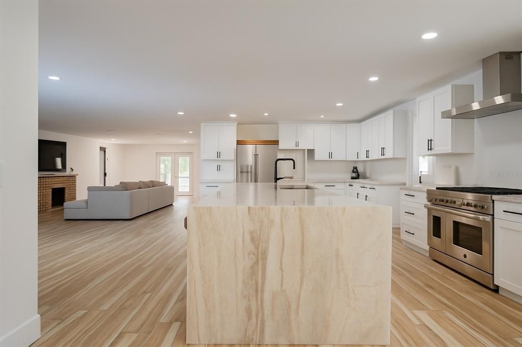 Fireplace, Interior, Kitchen, Living room, Recessed Lighting, Stainless Steel Appliances, Wood Texture Flooring