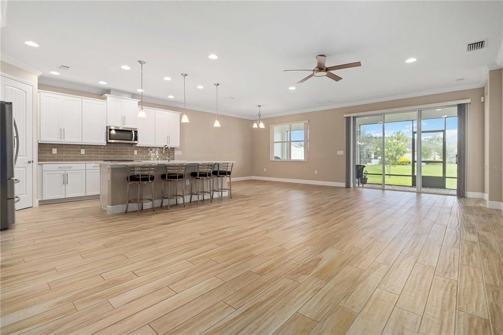 Empty room, Interior, Kitchen, Pendant Lights, Recessed Lighting, Stainless Steel Appliances, Wood Texture Flooring