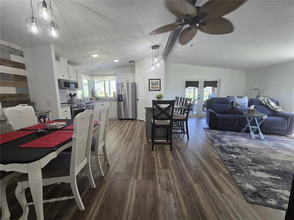 Dining room, Interior, Kitchen, Living room, Pendant Lights, Recessed Lighting, Stainless Steel Appliances, Wood Texture Flooring