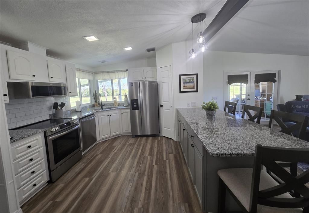 Dining room, Interior, Kitchen, Pendant Lights, Recessed Lighting, Stainless Steel Appliances, Wood Texture Flooring