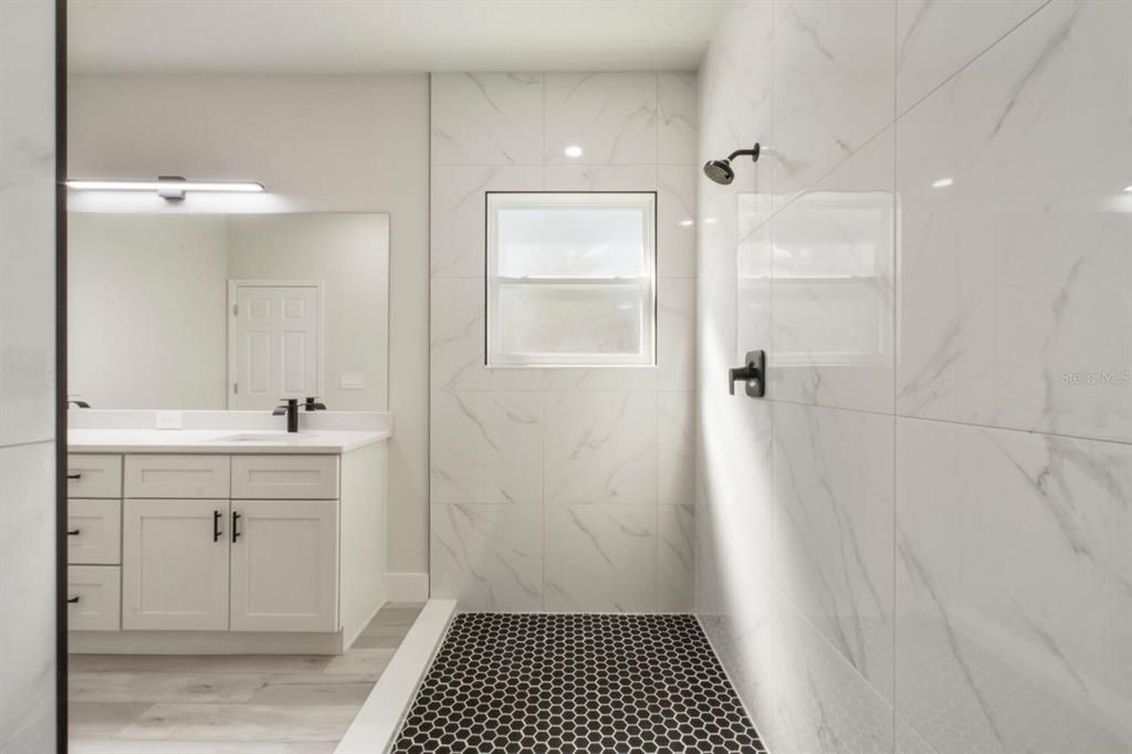 Bathroom, Dual Sink Vanities, Glass Shower, Interior, Marble Walls, Wood Texture Flooring