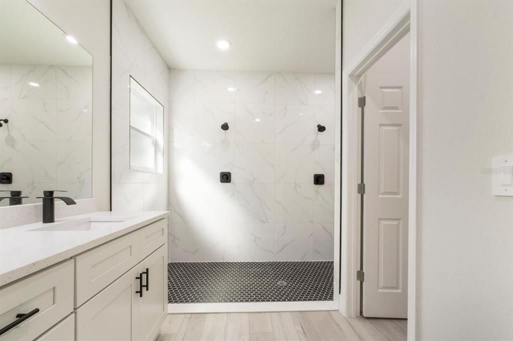 Bathroom, Glass Shower, Interior, Marble Walls, Recessed Lighting, Wood Texture Flooring