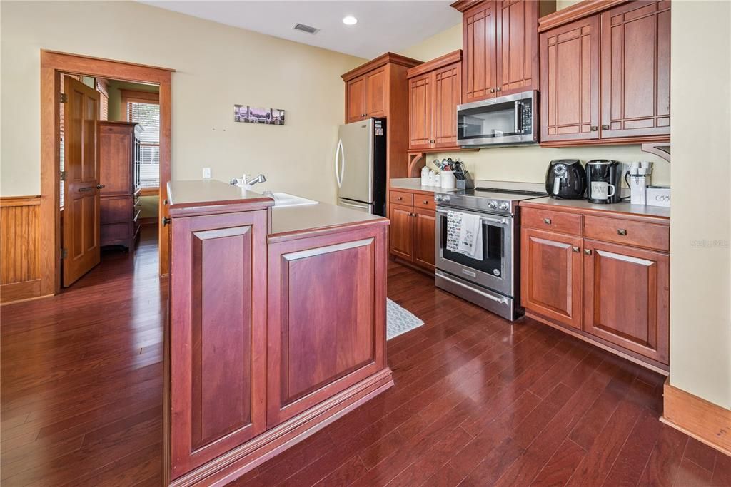 Interior, Kitchen, Recessed Lighting, Washer, Wood Texture Flooring