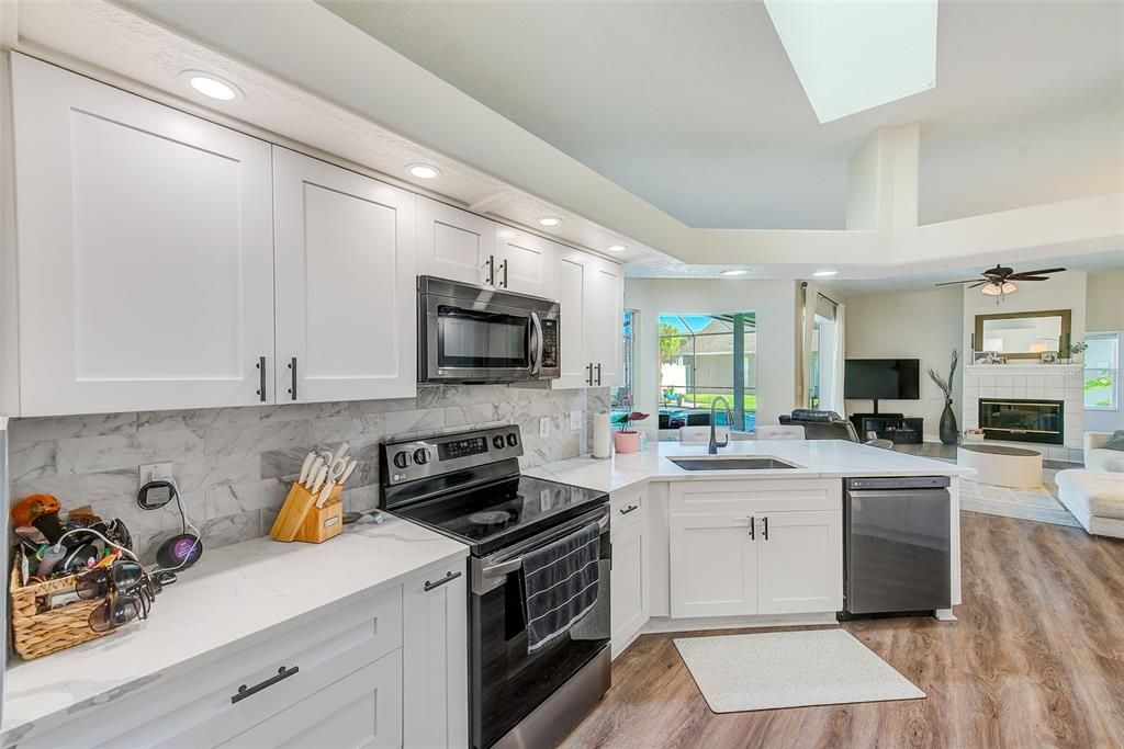 Fireplace, Interior, Kitchen, Recessed Lighting, Stainless Steel Appliances, Wood Texture Flooring