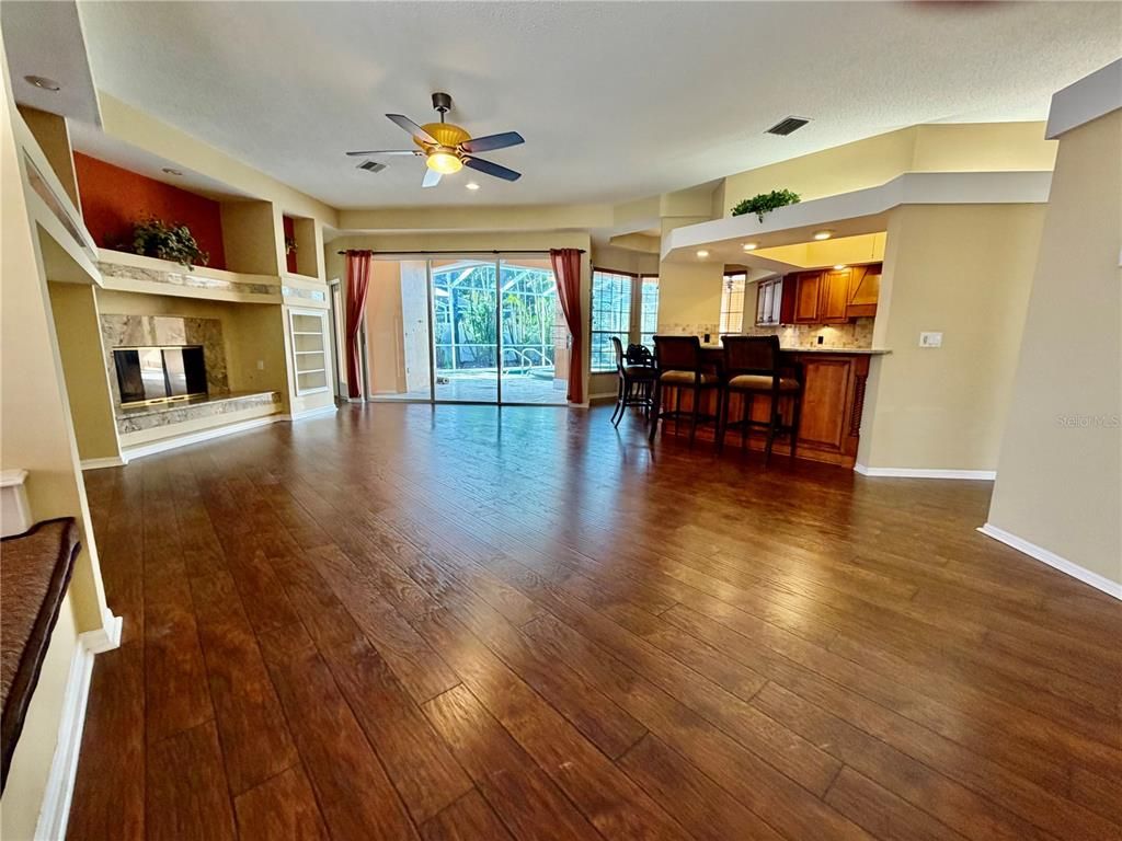 Dining room, Empty room, Fireplace, Interior, Kitchen, Recessed Lighting, Wood Texture Flooring