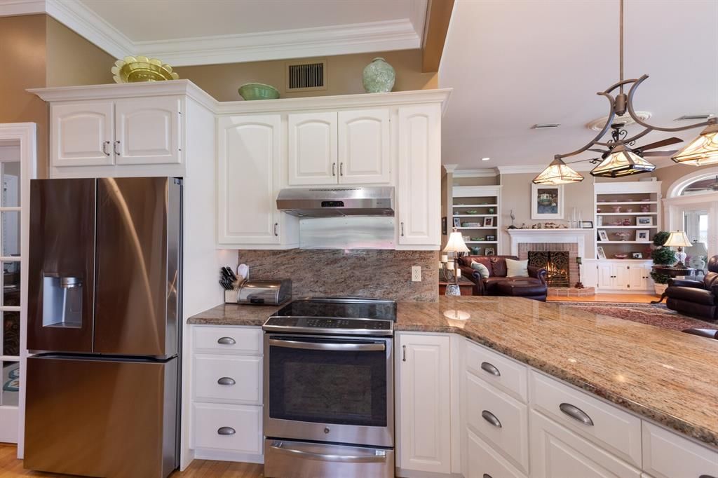 Fireplace, Interior, Kitchen, Pendant Lights, Recessed Lighting, Stainless Steel Appliances, Wood Texture Flooring