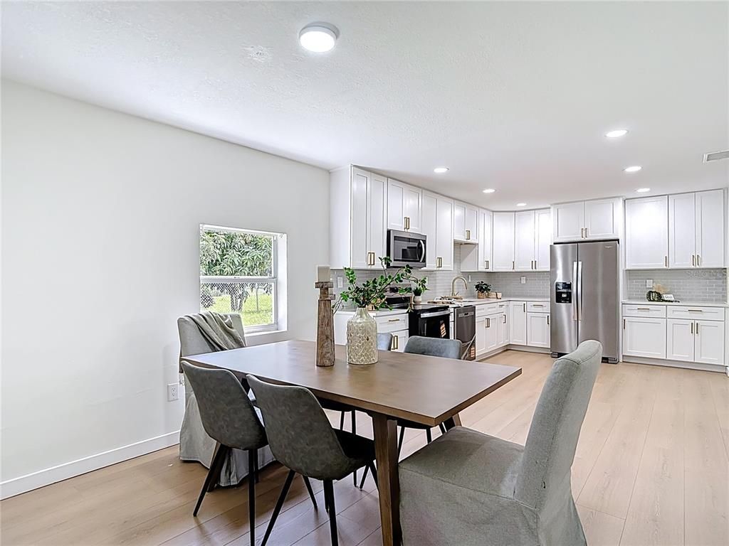 Dining room, Interior, Kitchen, Recessed Lighting, Stainless Steel Appliances, Wood Texture Flooring