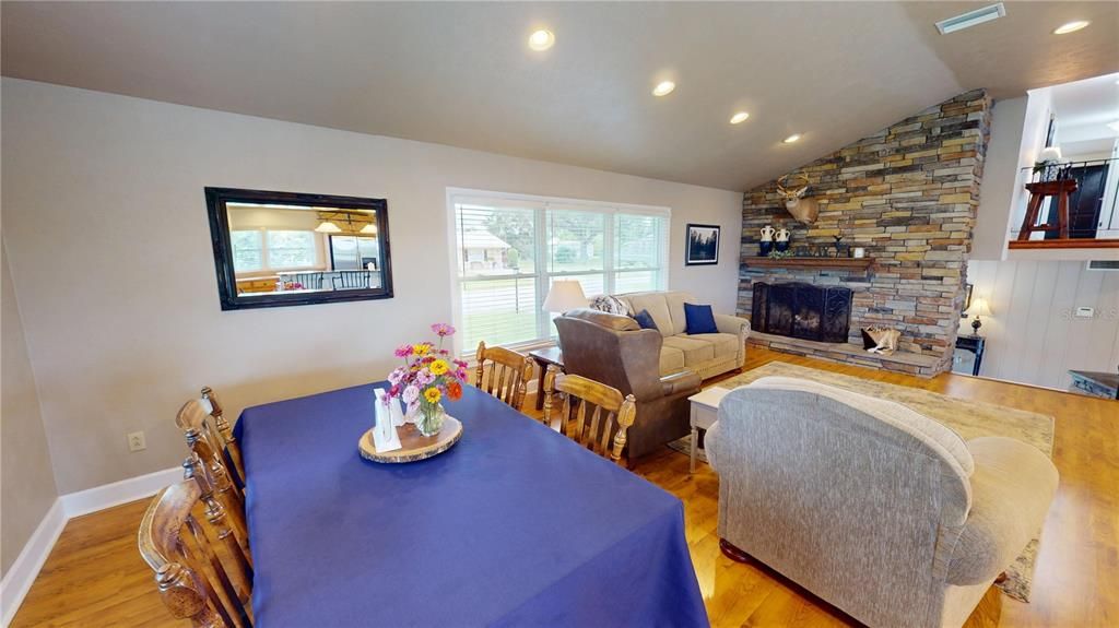 Dining room, Fireplace, Interior, Living room, Recessed Lighting, Stone Walls, Wood Texture Flooring