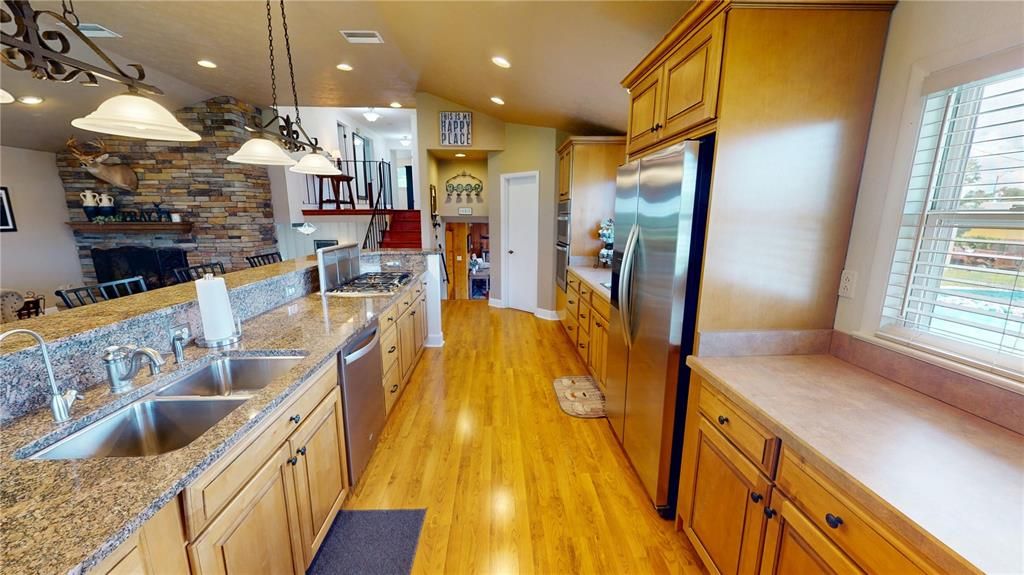 Interior, Kitchen, Pendant Lights, Recessed Lighting, Stainless Steel Appliances, Stone Walls, Wood Texture Flooring