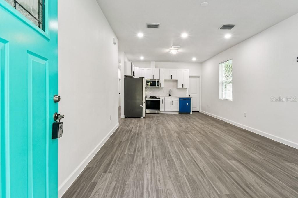 Empty room, Interior, Kitchen, Recessed Lighting, Stainless Steel Appliances, Wood Texture Flooring
