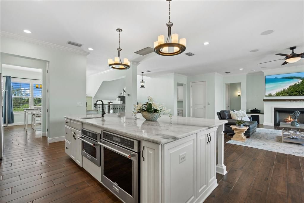 Dining room, Fireplace, Interior, Kitchen, Living room, Pendant Lights, Recessed Lighting, Stainless Steel Appliances, Wood Texture Flooring