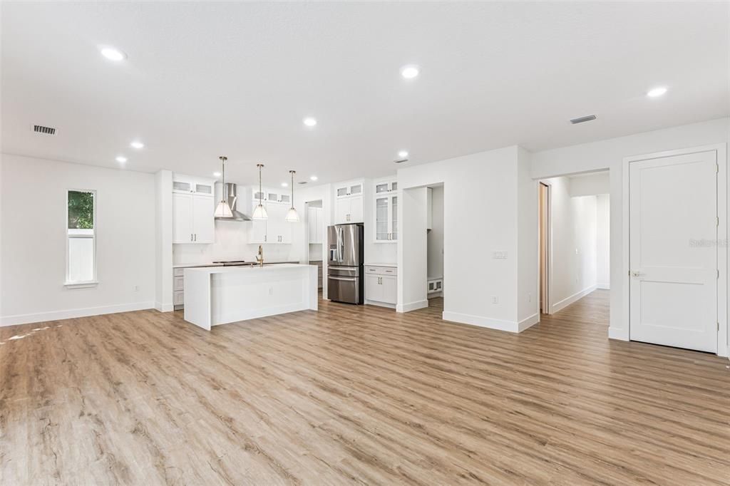 Empty room, Interior, Kitchen, Pendant Lights, Recessed Lighting, Stainless Steel Appliances, Wood Texture Flooring