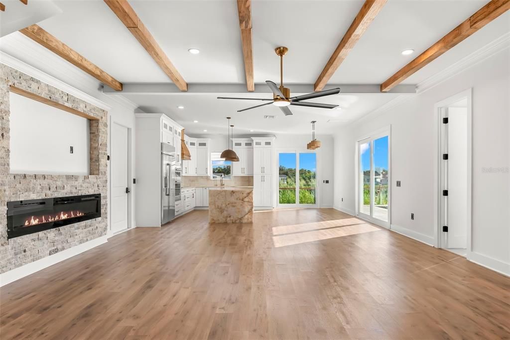 Empty room, Fireplace, Interior, Kitchen, Pendant Lights, Recessed Lighting, Wooden Beams, Wood Texture Flooring