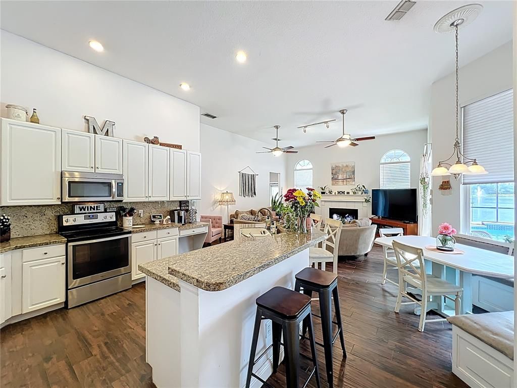 Dining room, Fireplace, Interior, Kitchen, Living room, Pendant Lights, Recessed Lighting, Stainless Steel Appliances, Wood Texture Flooring