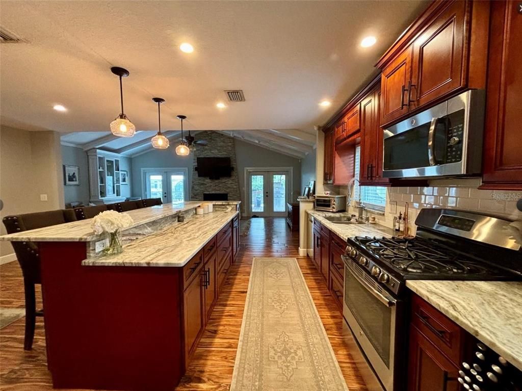 Fireplace, Interior, Kitchen, Pendant Lights, Recessed Lighting, Stainless Steel Appliances, Wood Texture Flooring