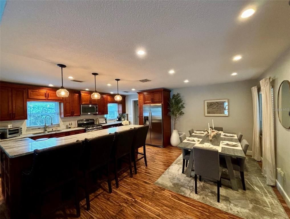 Dining room, Interior, Kitchen, Pendant Lights, Recessed Lighting, Stainless Steel Appliances, Wood Texture Flooring