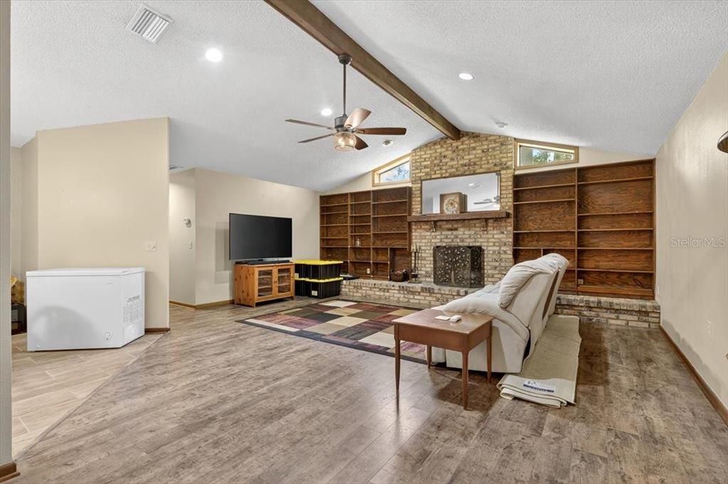 Fireplace, Interior, Living room, Recessed Lighting, Stone Walls, Wood Texture Flooring