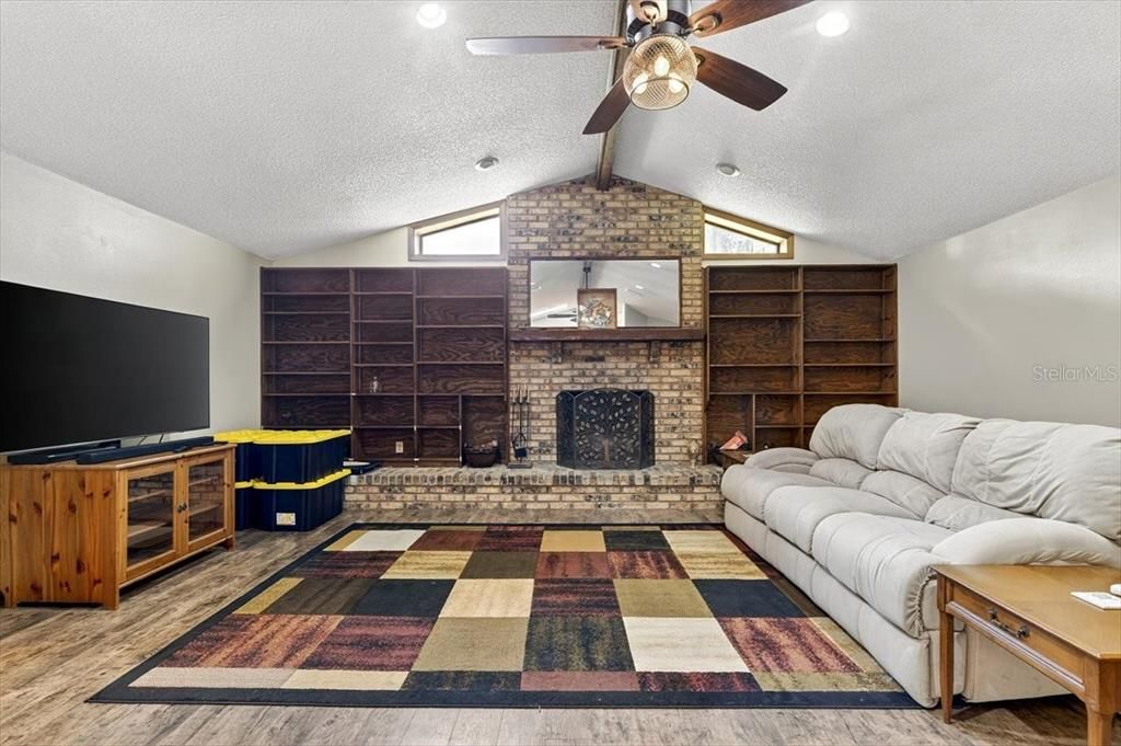 Fireplace, Interior, Living room, Recessed Lighting, Stone Walls, Wood Texture Flooring