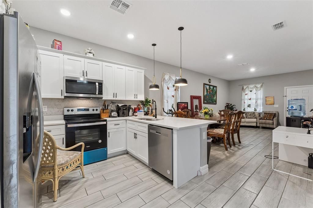 Dining room, Interior, Kitchen, Pendant Lights, Recessed Lighting, Stainless Steel Appliances, Wood Texture Flooring