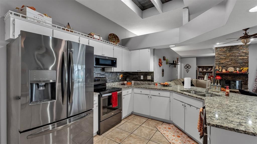 Fireplace, Interior, Kitchen, Recessed Lighting, Stainless Steel Appliances, Stone Walls