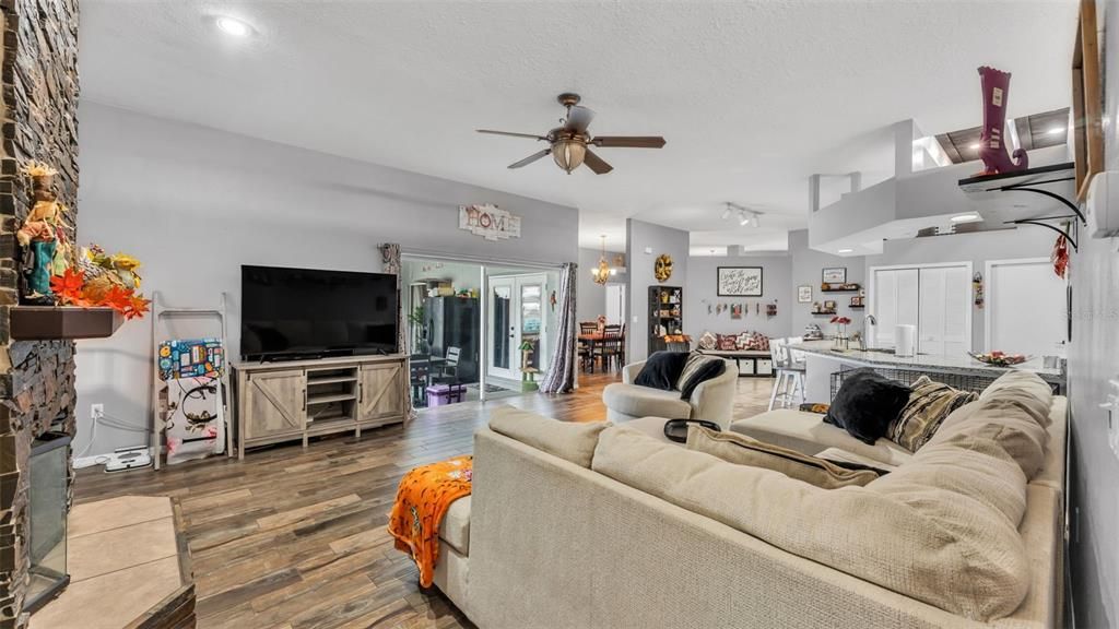 Dining room, Fireplace, Interior, Living room, Recessed Lighting, Wood Texture Flooring
