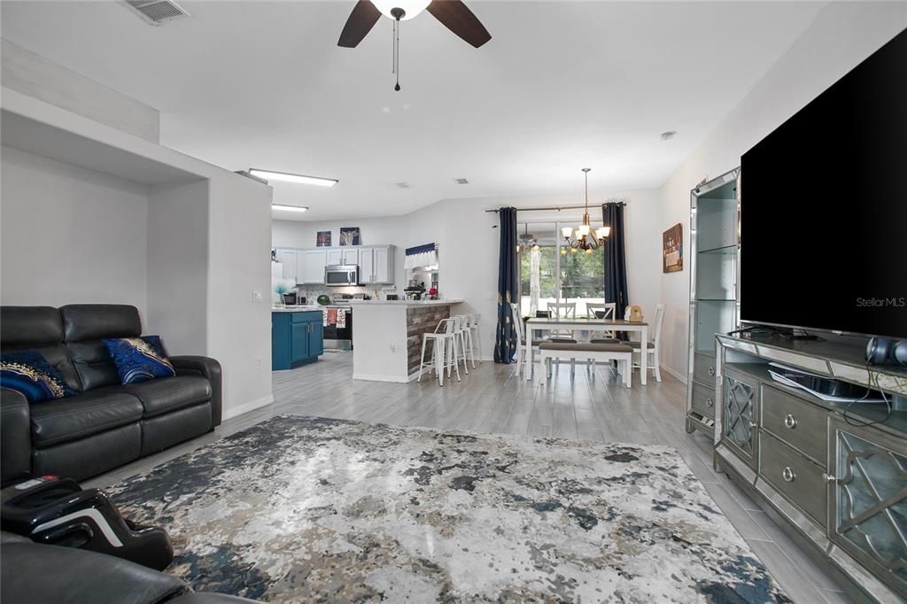 Chandelier, Dining room, Interior, Kitchen, Living room, Pendant Lights, Stainless Steel Appliances, Wood Texture Flooring