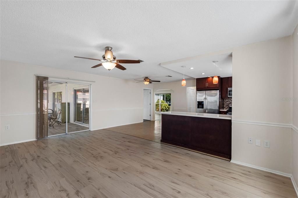 Empty room, Interior, Kitchen, Recessed Lighting, Stainless Steel Appliances, Wood Texture Flooring