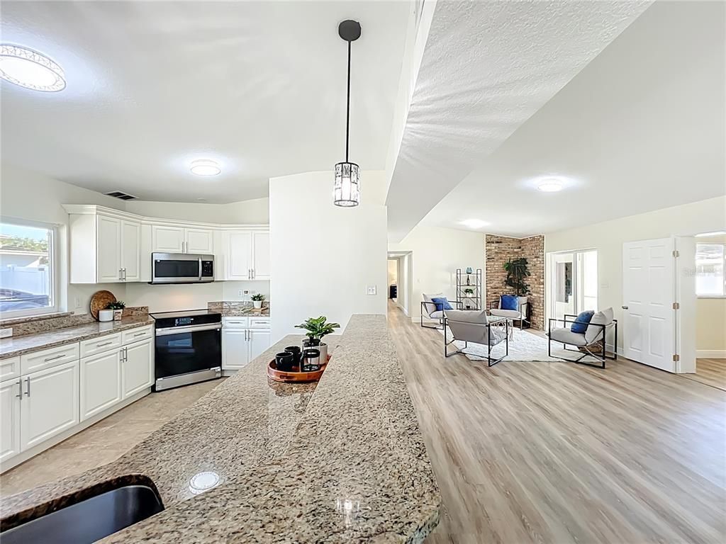 Interior, Kitchen, Living room, Pendant Lights, Stainless Steel Appliances, Stone Walls, Wood Texture Flooring