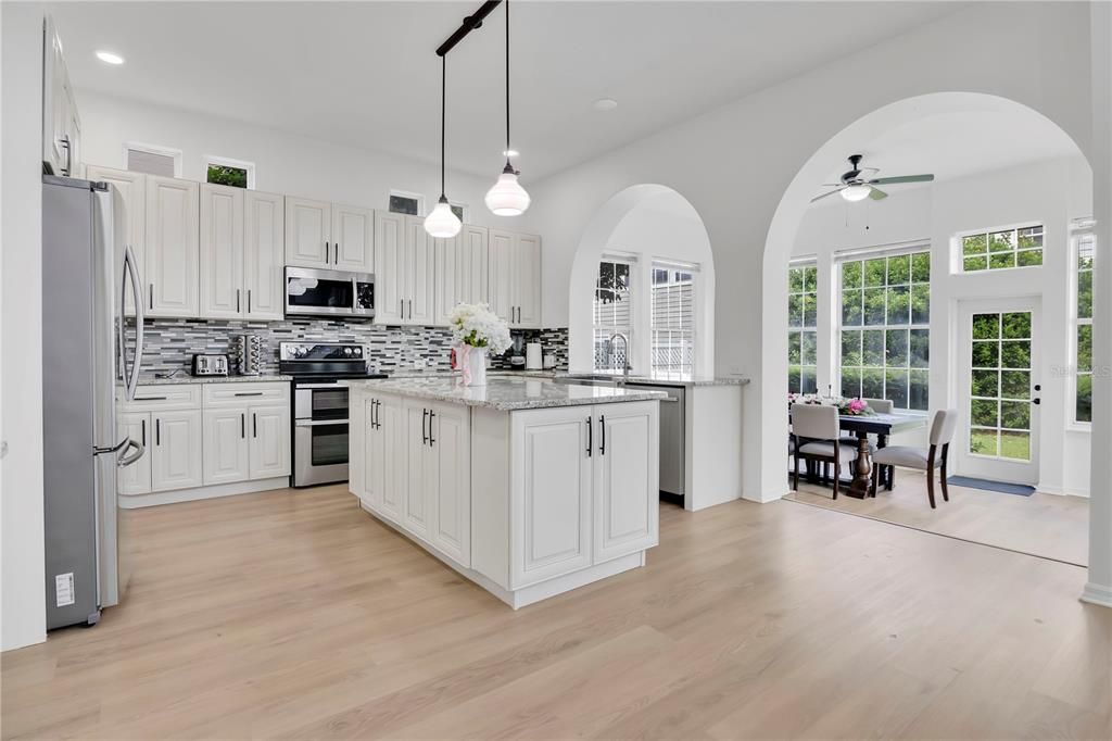 Dining room, Interior, Kitchen, Pendant Lights, Recessed Lighting, Stainless Steel Appliances, Wood Texture Flooring
