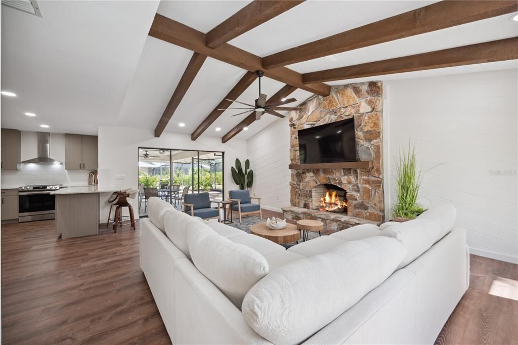 Fireplace, Interior, Kitchen, Living room, Recessed Lighting, Stainless Steel Appliances, Stone Walls, Wooden Beams, Wood Texture Flooring