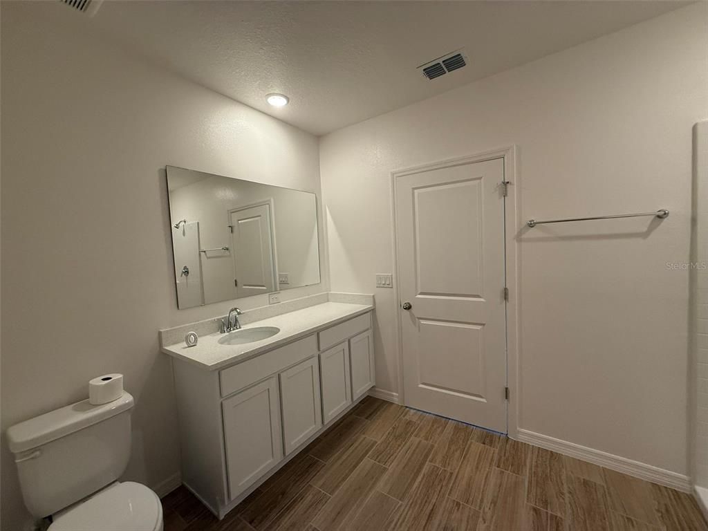 Bathroom, Dual Sink Vanities, Interior, Recessed Lighting, Wood Texture Flooring