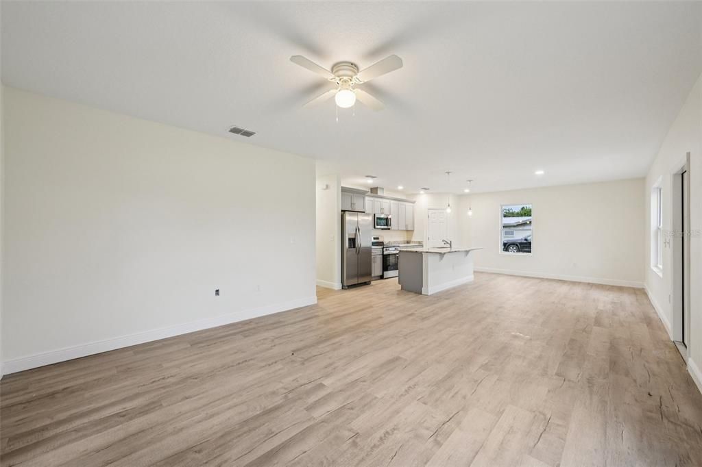 Empty room, Interior, Kitchen, Pendant Lights, Recessed Lighting, Stainless Steel Appliances, Wood Texture Flooring