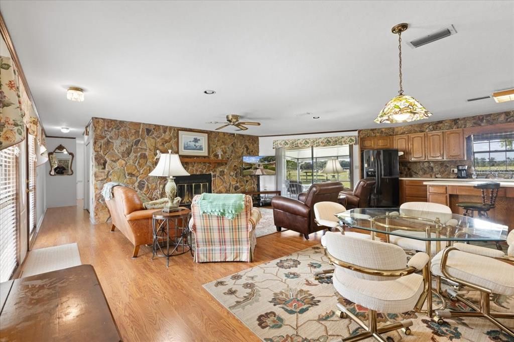 Dining room, Fireplace, Interior, Kitchen, Living room, Pendant Lights, Stone Walls, Wood Texture Flooring