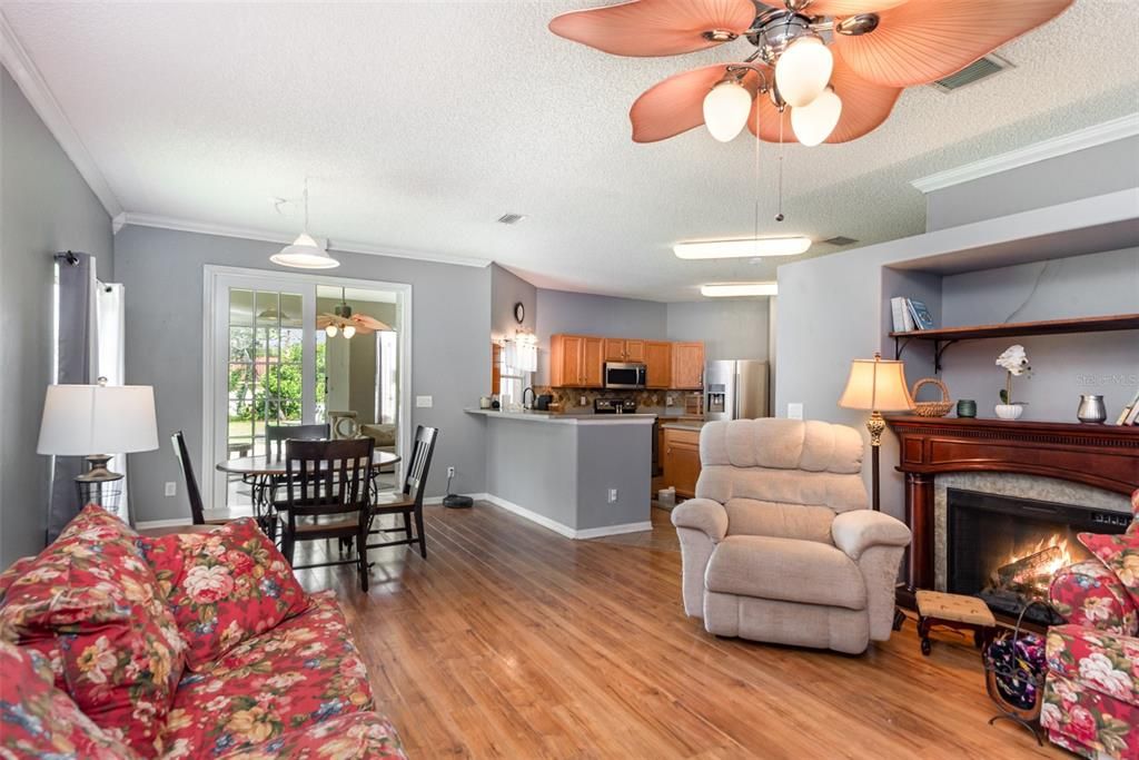 Dining room, Fireplace, Interior, Kitchen, Living room, Pendant Lights, Stainless Steel Appliances, Wood Texture Flooring