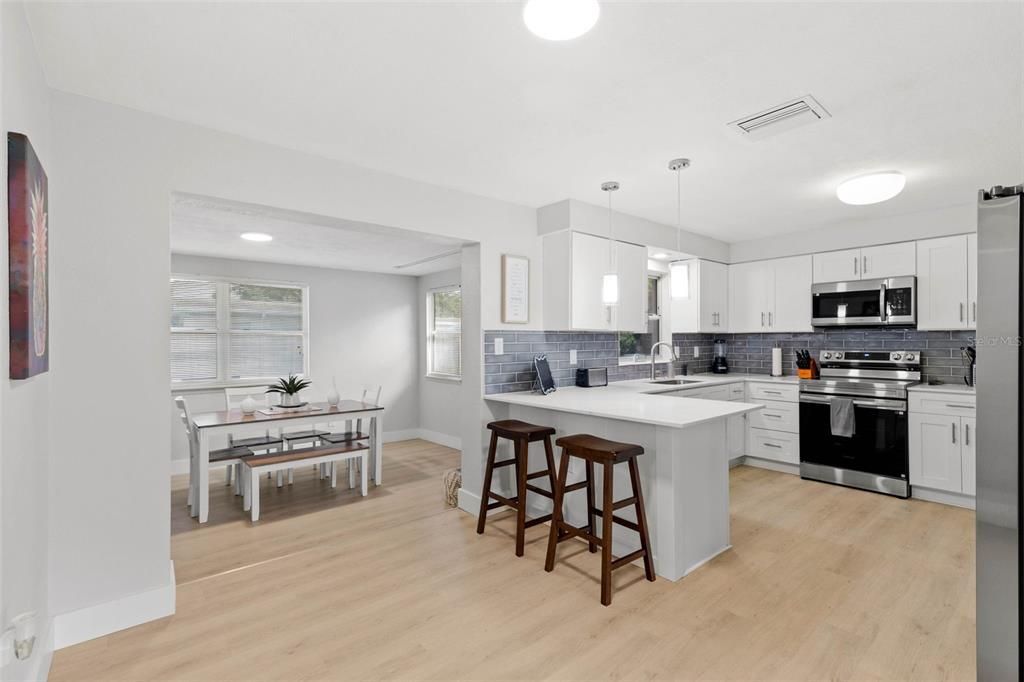 Dining room, Interior, Kitchen, Pendant Lights, Recessed Lighting, Stainless Steel Appliances, Wood Texture Flooring