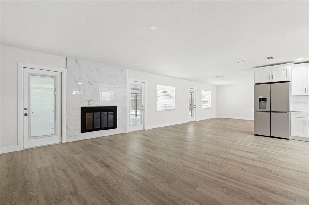 Empty room, Fireplace, Interior, Kitchen, Marble Walls, Recessed Lighting, Wood Texture Flooring