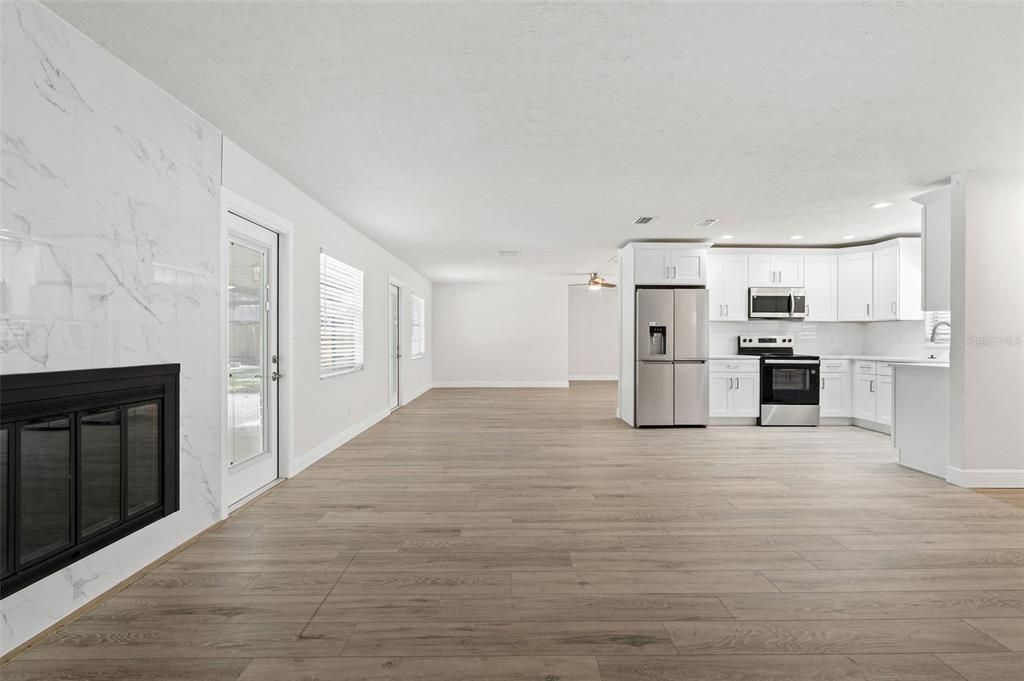 Interior, Kitchen, Marble Walls, Recessed Lighting, Stainless Steel Appliances, Wood Texture Flooring