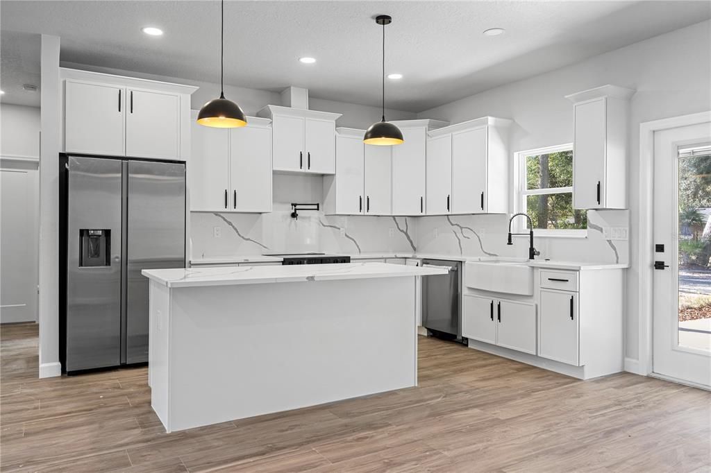 Interior, Kitchen, Marble Walls, Pendant Lights, Recessed Lighting, Stainless Steel Appliances, Wood Texture Flooring