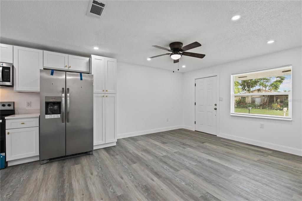Empty room, Interior, Kitchen, Recessed Lighting, Stainless Steel Appliances, Wood Texture Flooring
