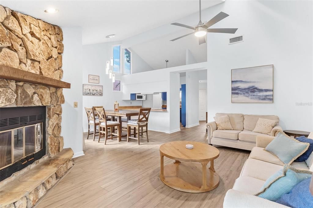 Dining room, Fireplace, Interior, Living room, Recessed Lighting, Stone Walls, Wood Texture Flooring