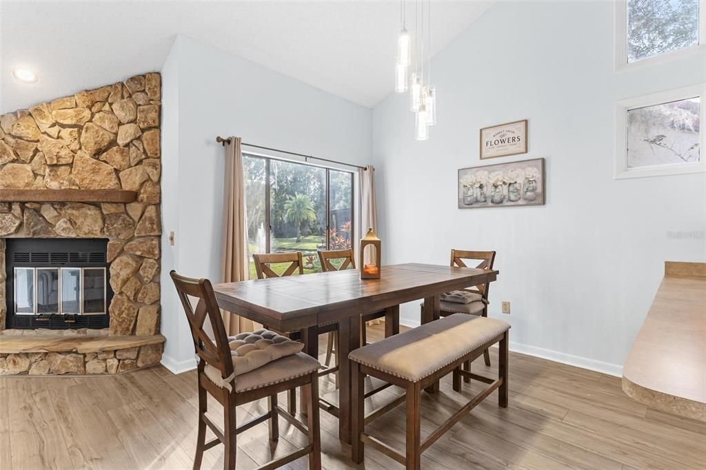 Dining room, Fireplace, Interior, Pendant Lights, Recessed Lighting, Stone Walls, Wood Texture Flooring