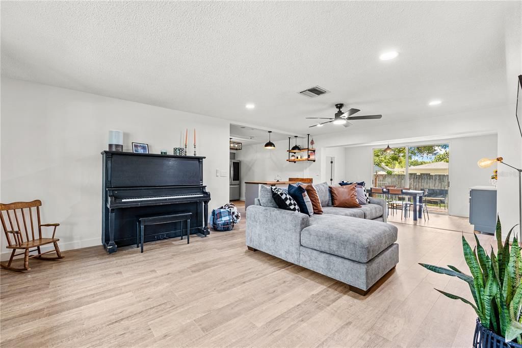 Dining room, Interior, Living room, Pendant Lights, Piano, Recessed Lighting, Wood Texture Flooring