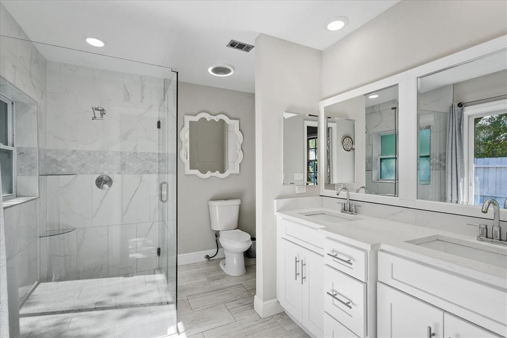 Bathroom, Dual Sink Vanities, Glass Shower, Interior, Marble Walls, Recessed Lighting, Wood Texture Flooring
