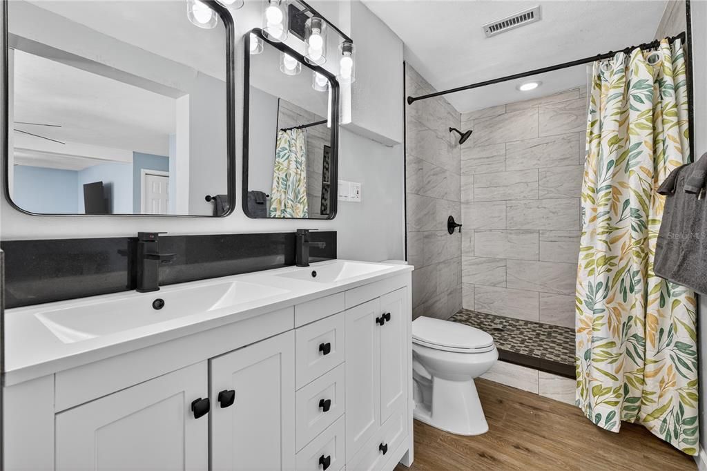 Bathroom, Dual Sink Vanities, Interior, Marble Walls, Recessed Lighting, Wood Texture Flooring